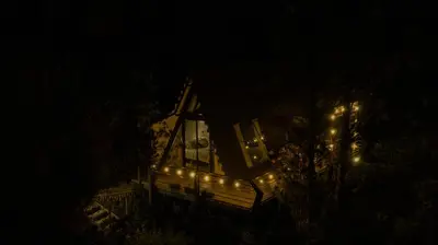 a house lit up at night with lights on it at Ecoluxury Glamping in San Antonio de Pereira
