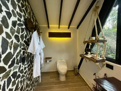 a bathroom with a toilet in a room at Ecoluxury Glamping in San Antonio de Pereira