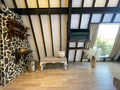 a room with a chair and a large window at Ecoluxury Glamping in San Antonio de Pereira