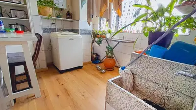 a kitchen with a refrigerator and some plants in a room at Habitación Privada en Apartamento, Conquistadores in Medellín
