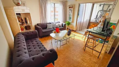 a living room with a couch and a table at Habitación Privada en Apartamento, Conquistadores in Medellín