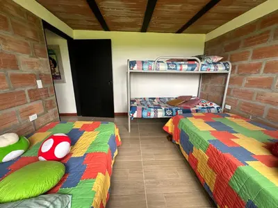 two beds in a room with two bunk beds at Casa de Campo en San Pedro in San Pedro