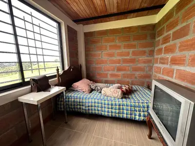 a little girl sleeping on a bed in a room at Casa de Campo en San Pedro in San Pedro