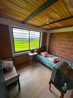 a living room with a bed and a window at Casa de Campo en San Pedro in San Pedro