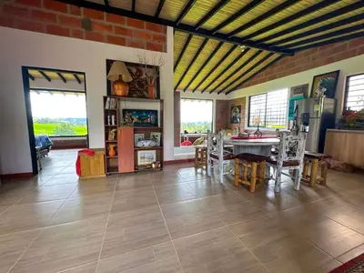 a living room with a table and chairs at Casa de Campo en San Pedro in San Pedro