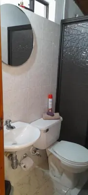a bathroom with a toilet and a sink and a mirror at M76 apartamento acogedor en Medellin in Medellín