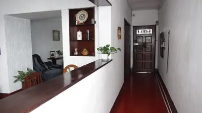 a hallway with a long counter in a room at Hostal prado colonial in Medellín