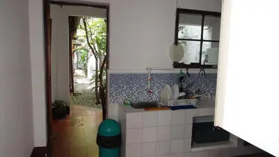 a small kitchen with a sink and a window at Hostal prado colonial in Medellín