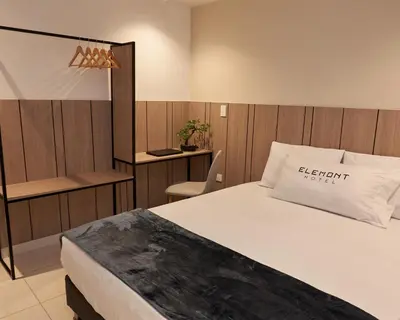 a bedroom with a bed with a sign on it at Elemont Hotel in Medellín