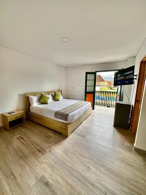 a bedroom with a bed and a television in it at ALTO VERDE HOTEL in Guatapé
