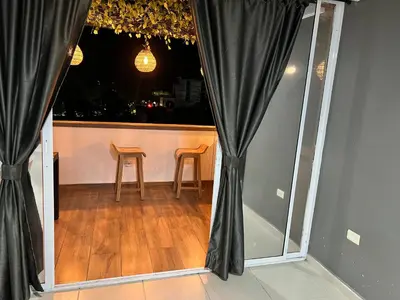 a room with black curtains and a table and two chairs at Hotel Entre Parques in La Dorada