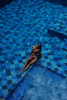 a woman floating in a swimming pool at Bio Rio Hotel in San Jerónimo