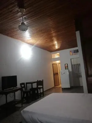 a bedroom with a bed and a desk with a computer at casa de relajación lowcost in La Dorada