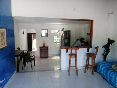 a kitchen and living room with a person in the kitchen at Casa lowcost relajación total! in La Dorada