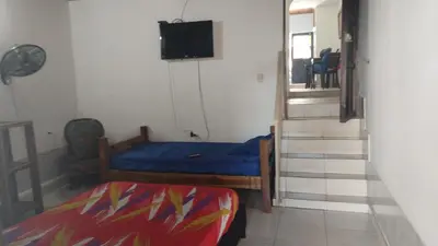 a small room with a bed and a tv at Casa lowcost relajación total! in La Dorada