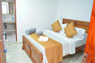 a bedroom with a bed and a table with a towel on it at HOTEL EL VALENCIA in Sonsón