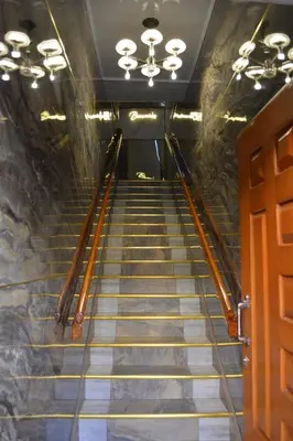 a flight of stairs in a building with a door at HOTEL EL VALENCIA in Sonsón
