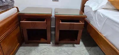 two nightstands next to a bed in a room at HOTEL EL VALENCIA in Sonsón