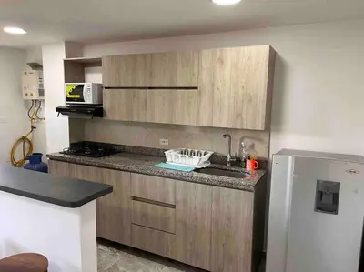 a kitchen with a sink and a refrigerator at Sencillo apartamento en Guatape in Guatapé