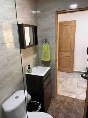 a bathroom with a toilet and a sink and a shower at Sencillo apartamento en Guatape in Guatapé