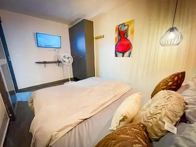 a hotel room with two beds and a fan at Red apartment excelente ubicacion Laurles Los molinos in Medellín