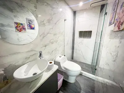a bathroom with a toilet and a sink and a shower at Red apartment excelente ubicacion Laurles Los molinos in Medellín