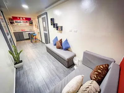 a living room with a couch and a table at Red apartment excelente ubicacion Laurles Los molinos in Medellín