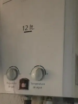 a white stove with two knobs on it at Red apartment excelente ubicacion Laurles Los molinos in Medellín