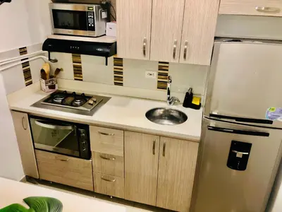 a kitchen with a stainless steel refrigerator and a sink at 1009 Apartamento acogedor en el poblado Medellín in Medellín