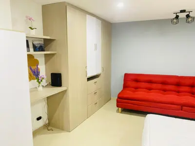 a living room with a red couch in a room at 1009 Apartamento acogedor en el poblado Medellín in Medellín