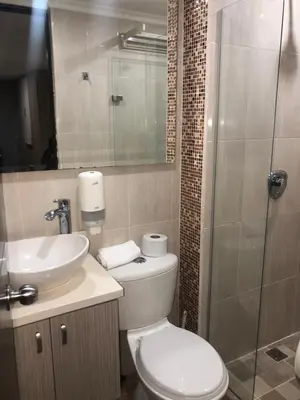 a bathroom with a toilet and a sink and a shower at 1009 Apartamento acogedor en el poblado Medellín in Medellín