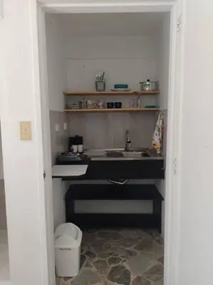 a kitchen with a sink and a trash can at Acogedor Apartaestudio Santa Fe in Medellín