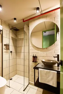 a bathroom with a sink and a glass shower at Urbit Social Lofts in Medellín