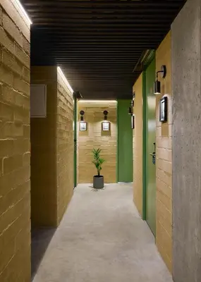 a hallway with green walls and a potted plant at Urbit Social Lofts in Medellín
