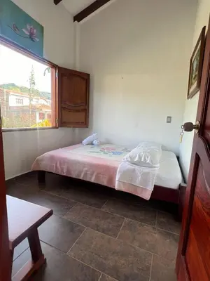 a bedroom with a bed and a window at Campo Bonito in Jericó