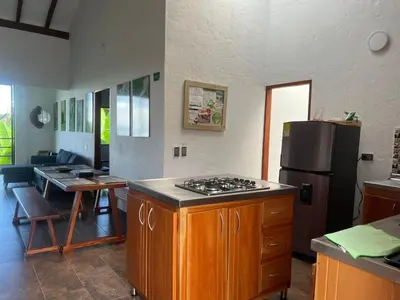 a kitchen with a stove and a refrigerator at Campo Bonito in Jericó