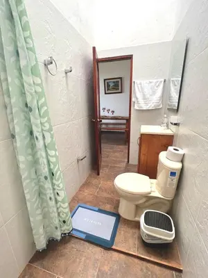 a bathroom with a toilet and a shower with a scale at Campo Bonito in Jericó