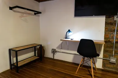 a room with a desk and a chair and a basketball hoop at Casa Moore in Medellín