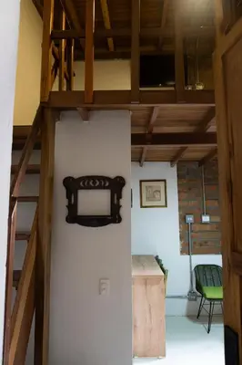 a white refrigerator in a room with a loft at Casa Moore in Medellín