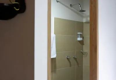 a bathroom with a shower with a glass door at Casa Moore in Medellín
