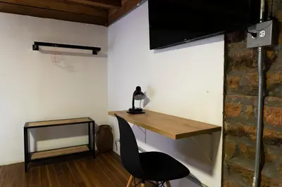 a desk and a chair in a room with a basketball hoop at Casa Moore in Medellín