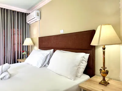 a hotel room with a bed and a lamp at DUO BOUTIQUE HOTEL in Medellín