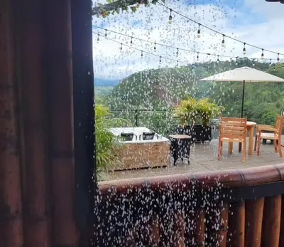 a patio with a table and chairs and an umbrella at AVANI Boutique Hotel in Norcasia