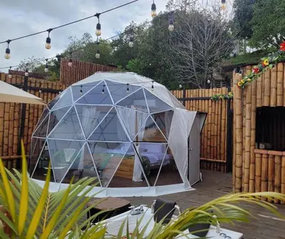 a gazebo in a backyard with a wooden fence at AVANI Boutique Hotel in Norcasia