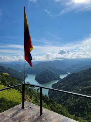 a flag on the edge of a lookout with a view of a lake at AVANI Boutique Hotel in Norcasia
