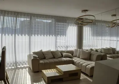 a living room with a couch and a large window at apto poblado a 8 min de provenza con free parking in Medellín
