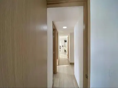 a hallway with a hallway leading into a room with a hallway at apto poblado a 8 min de provenza con free parking in Medellín