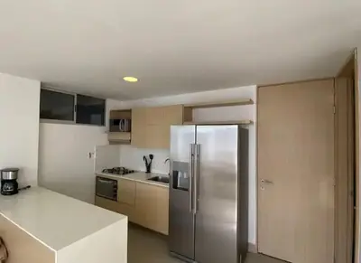 a kitchen with a stainless steel refrigerator in it at apto poblado a 8 min de provenza con free parking in Medellín