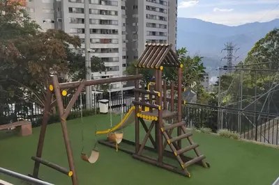 a playground with a slide and a swing at apto poblado a 8 min de provenza con free parking in Medellín