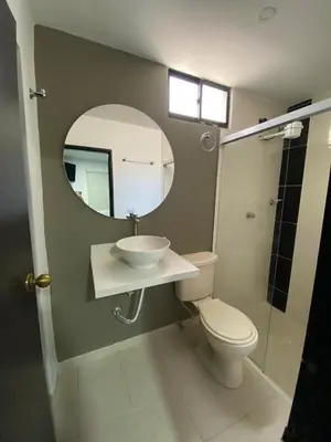 a bathroom with a sink and a toilet and a mirror at 33 Hotel Bulerias in Medellín